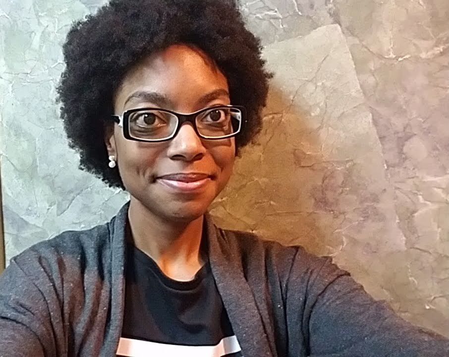A woman with glasses and a black shirt
