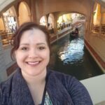 Lisa 3 A woman is taking a selfie in front of a canal.